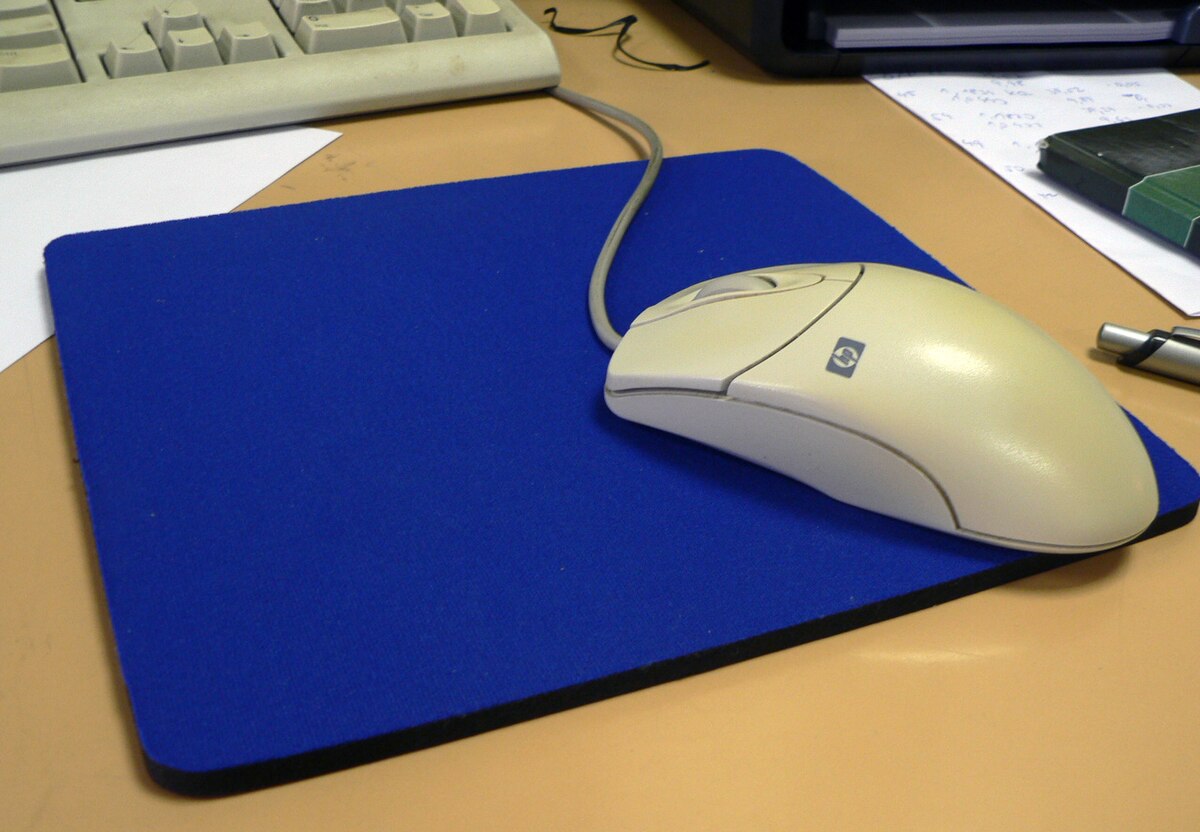 A clean computer mouse on a flat surface.