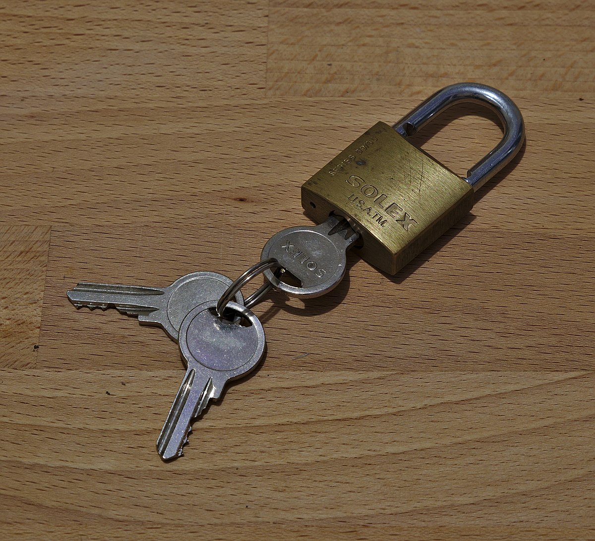 A locked padlock with a key next to it.