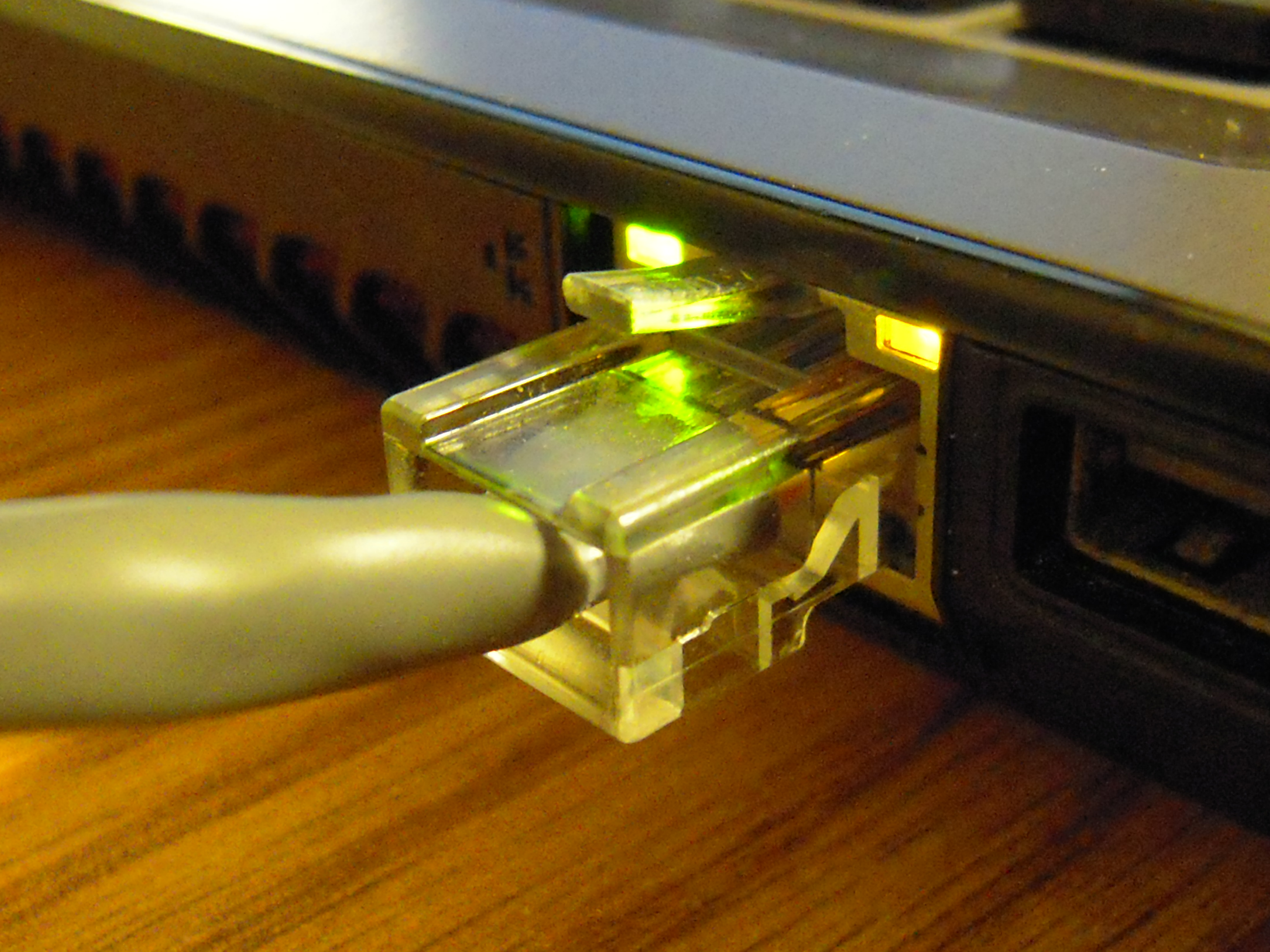 A network cable being plugged into a device.